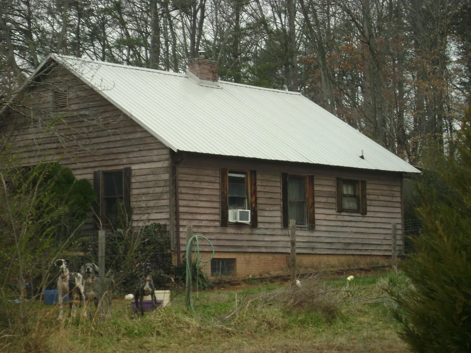 White metal roof on an old wood sided farmhouse, from a Metal Roof Installation job in Groton